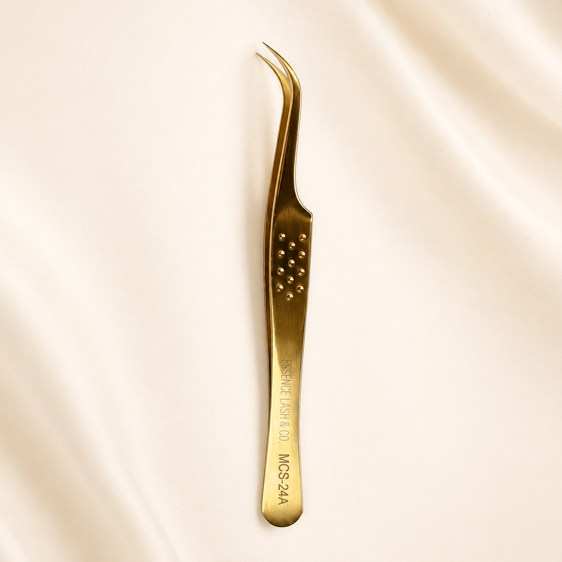 MCS-24A gold tweezer on ivory satin background