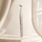 Essira 6A-SA silver ultra volume boot tweezer on a luxury cream background