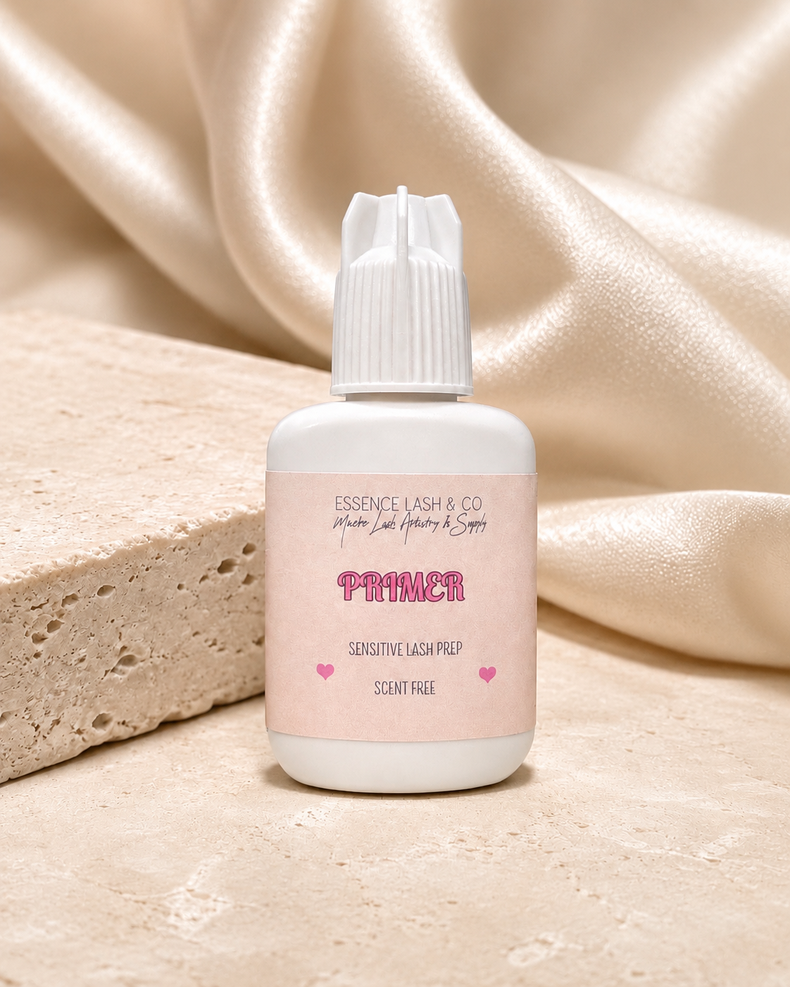 Essira Lash Primer on cream satin and travertine background
