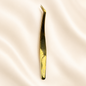MCS-19 gold tweezer on ivory satin background