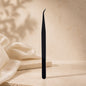 Essira Noir F1 straight isolation tweezer on cream luxury background