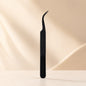 Essira Noir F3 curved isolation tweezer on cream luxury background