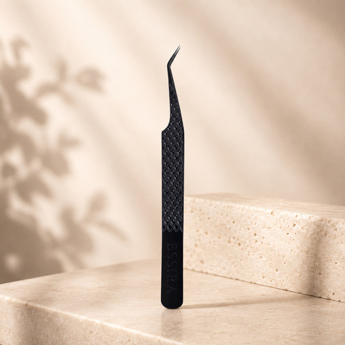 Essira Noir F4 45 degree volume tweezer on cream luxury background