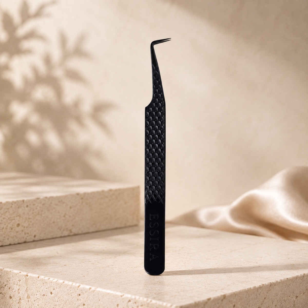 Essira Noir F8 90 degree volume tweezer on cream luxury background
