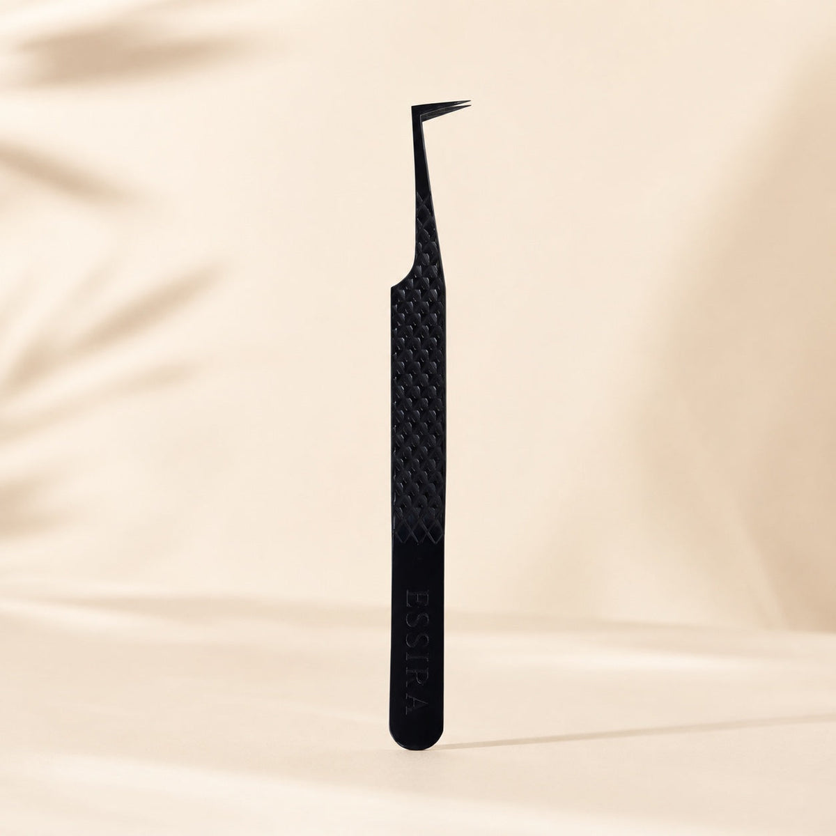 Essira Noir F9 L-boot mega volume tweezer on cream luxury background