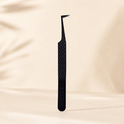 Essira Noir F9 L-boot mega volume tweezer on cream luxury background