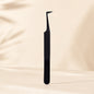 Essira Noir F9 L-boot mega volume tweezer on cream luxury background