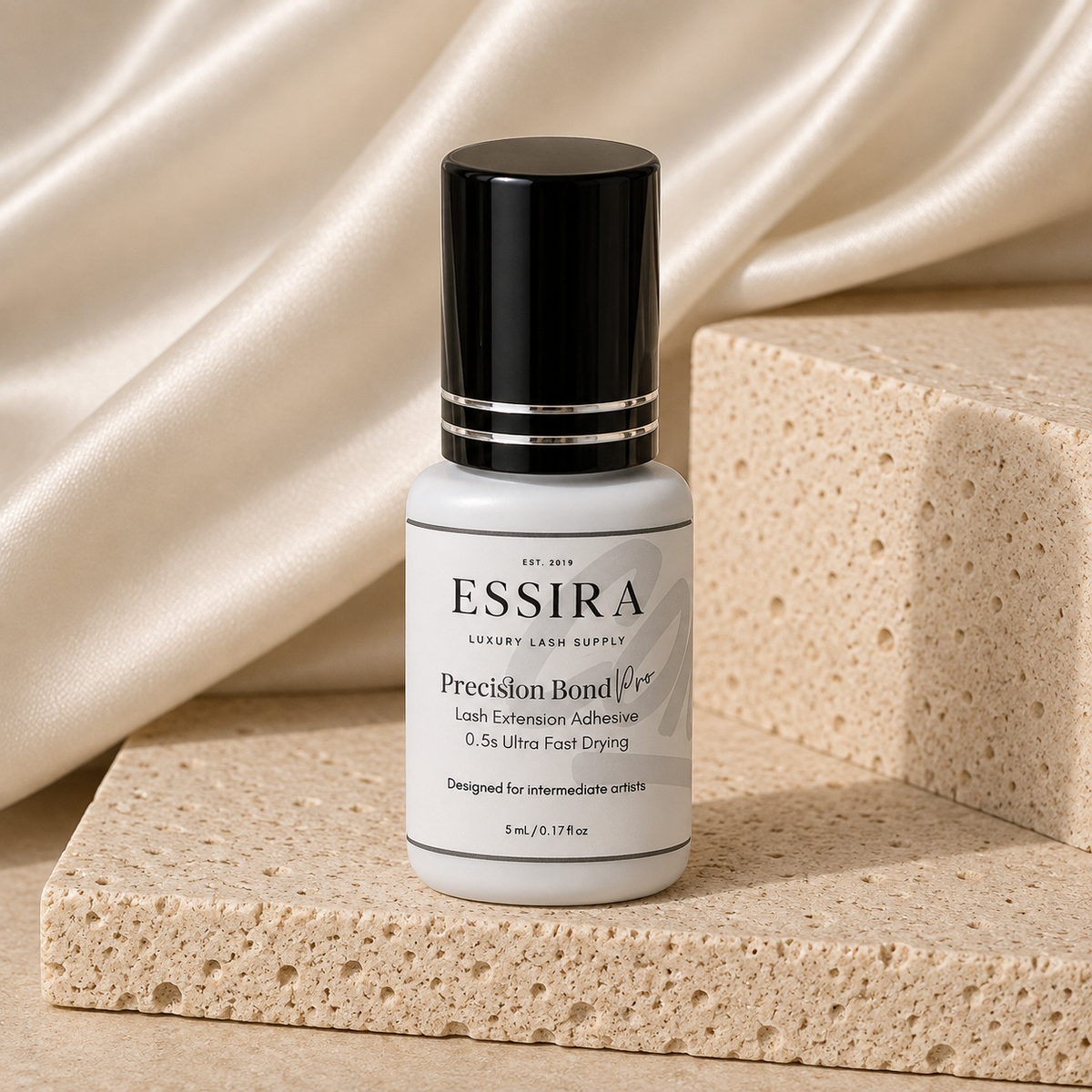 Essira Precision Bond Pro adhesive on cream satin and travertine background