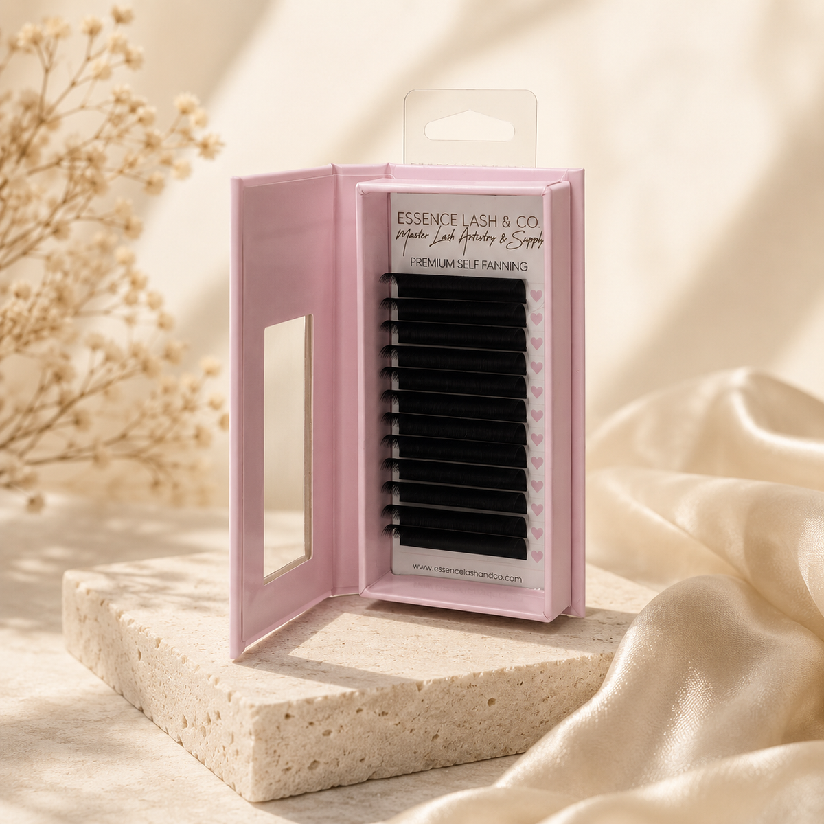 Pink self-flowering volume lash trays on a warm cream luxury background