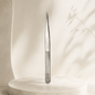 Essira ST-12 silver angled tweezer on a luxury cream background